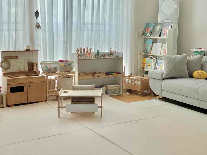 Soft beige natural-toned living room featuring children's toys and wooden furniture in a warm and cozy atmosphere