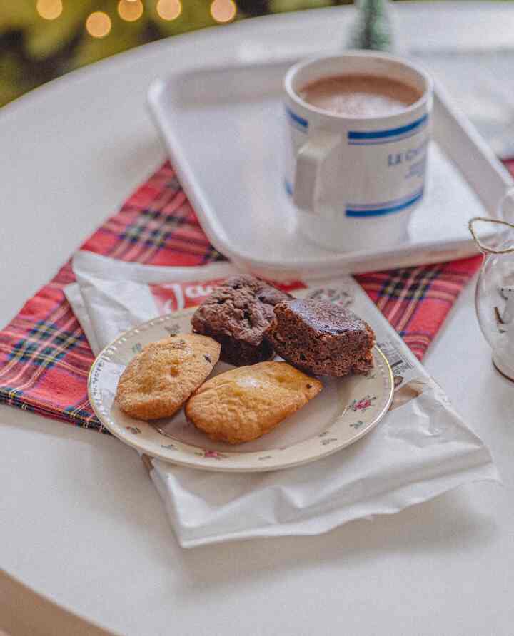 A retro-style floral plate and coffee cup placed on a white-toned table creating a cozy dessert setting