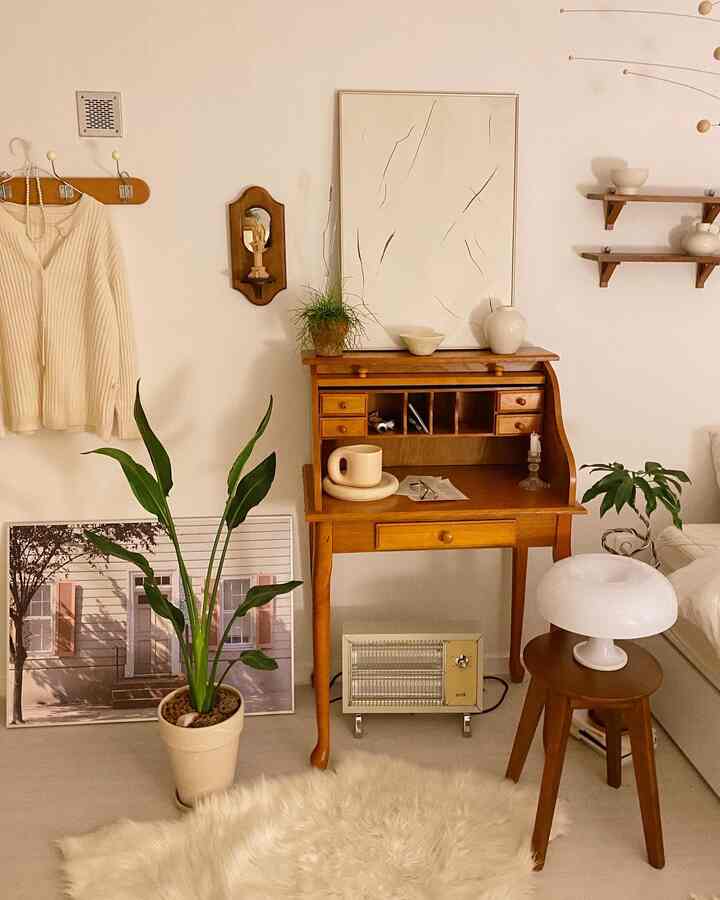 Natural toned studio apartment featuring wooden furniture and plants creating a cozy atmosphere