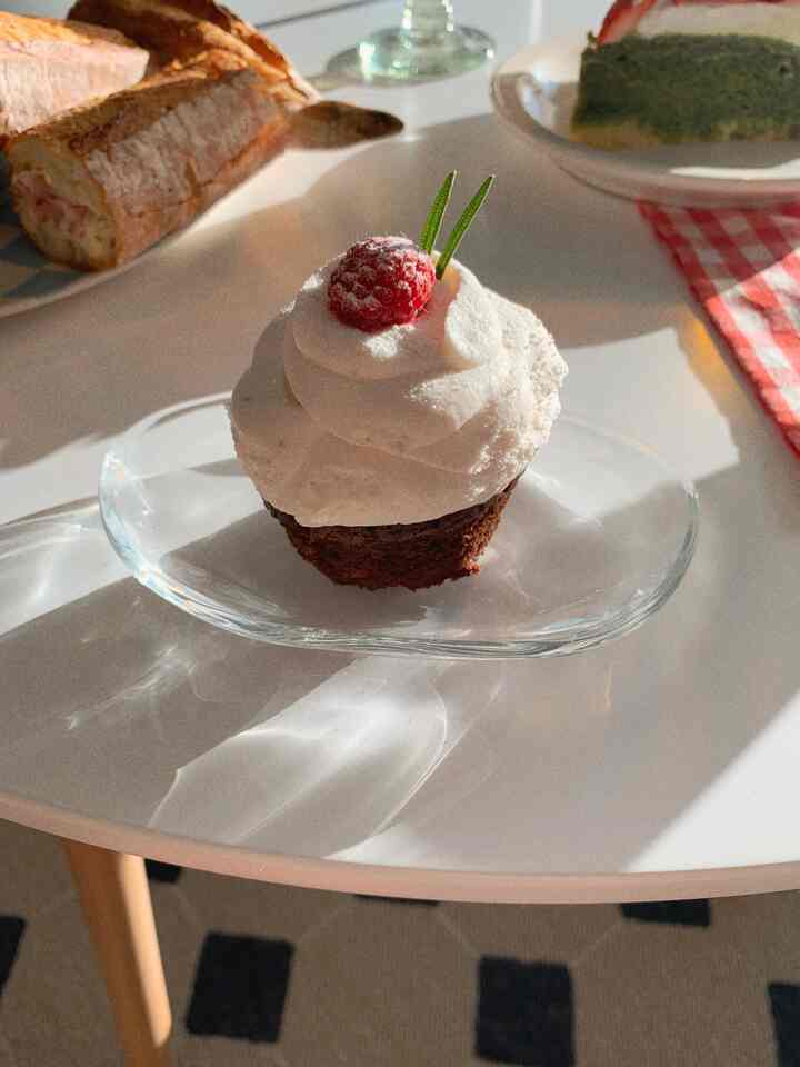 Bright white dining table featuring cakes and bread, creating a clean and vintage home cafe atmosphere