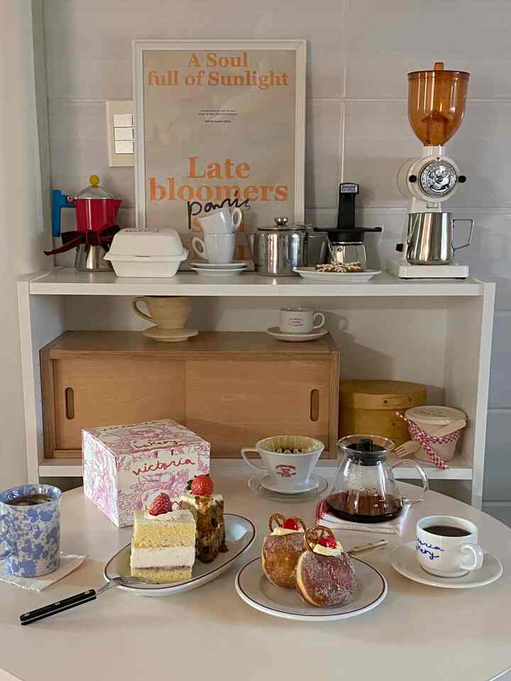 Cream white and wood tone home cafe featuring Victoria bakery cakes and coffee equipment with a cozy warm atmosphere