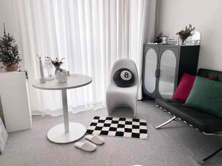 Modern living room with white curtains and sleek furniture creating a clean atmosphere