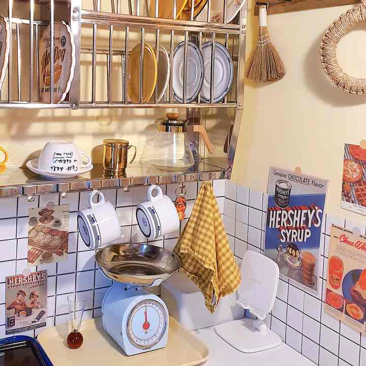 Butter yellow kitchen space with retro accessories and a home cafe vibe, featuring organized racks and vintage elements