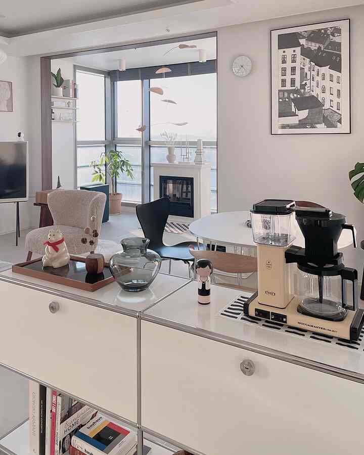 Natural tone living and dining room featuring wood and white furniture with a cozy and clean atmosphere