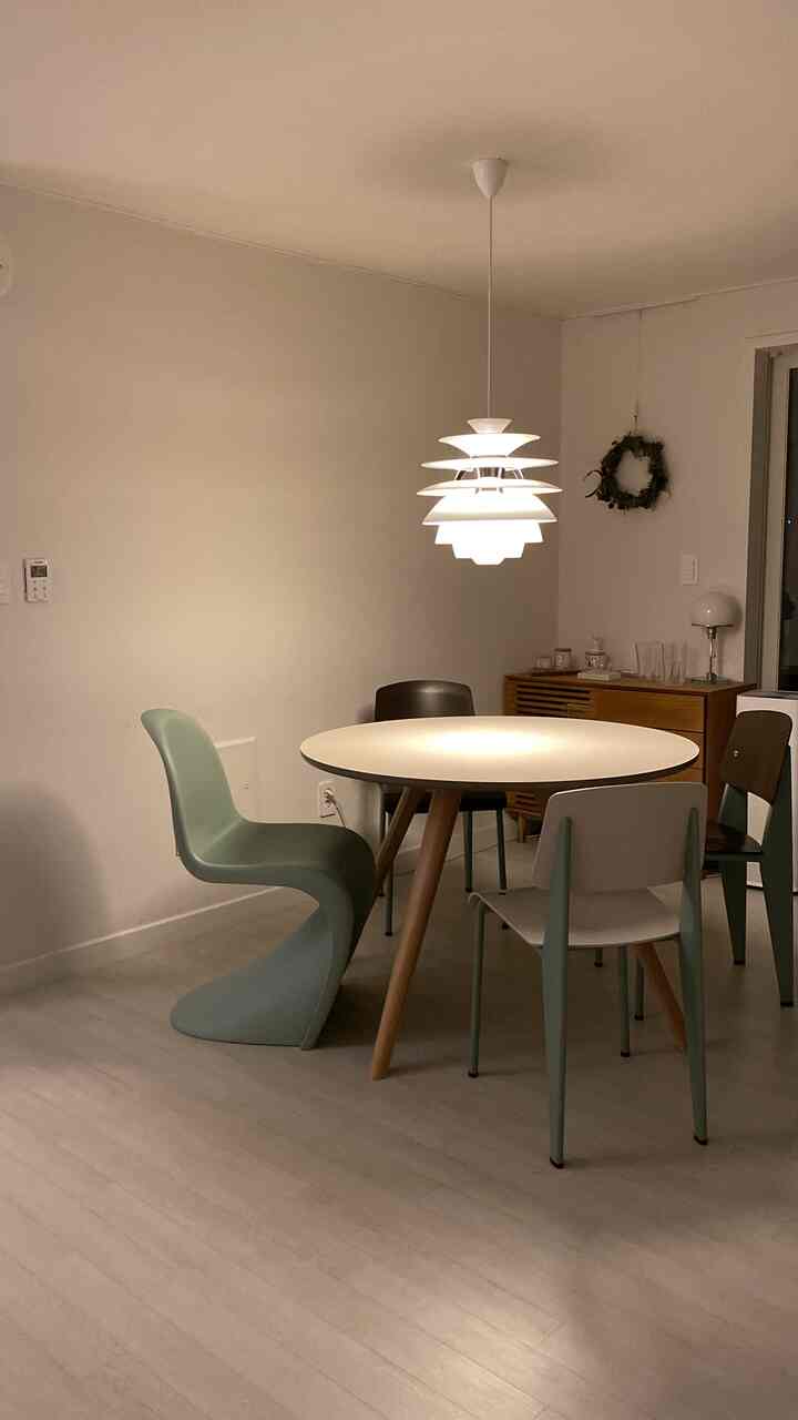 Soft white and wood tones with mint-colored chairs in a dining room, cozy and modern atmosphere