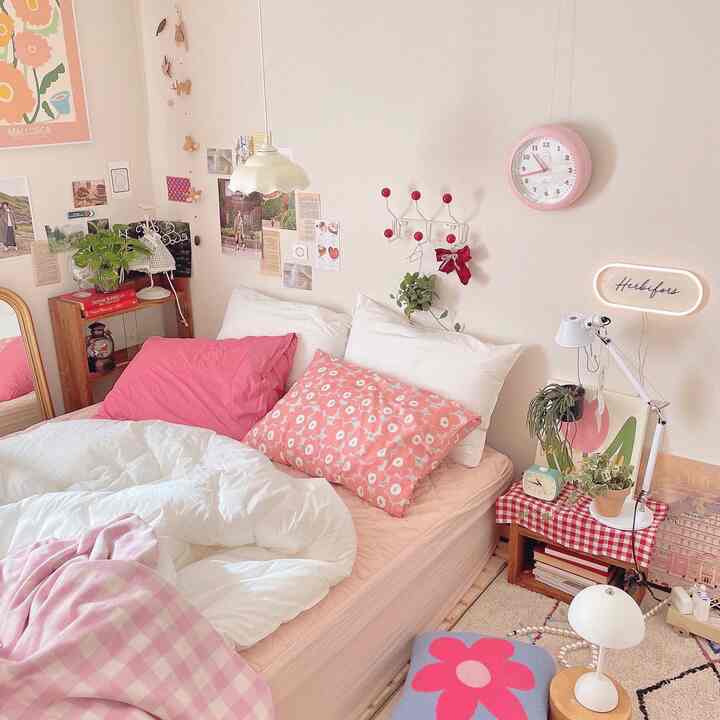 Pink and white toned bedroom featuring pillows and decor creating a cozy and simple space