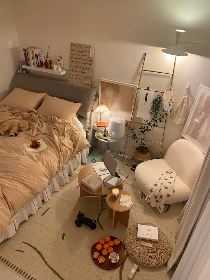 Natural-toned bedroom featuring beige bedding, round tables, and cozy modern natural interior