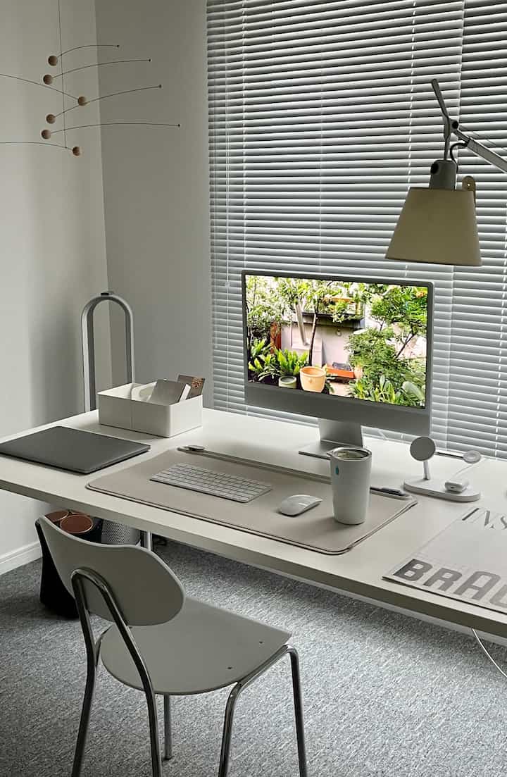 White and gray toned home office study featuring a desk and iMac computer in a clean modern space