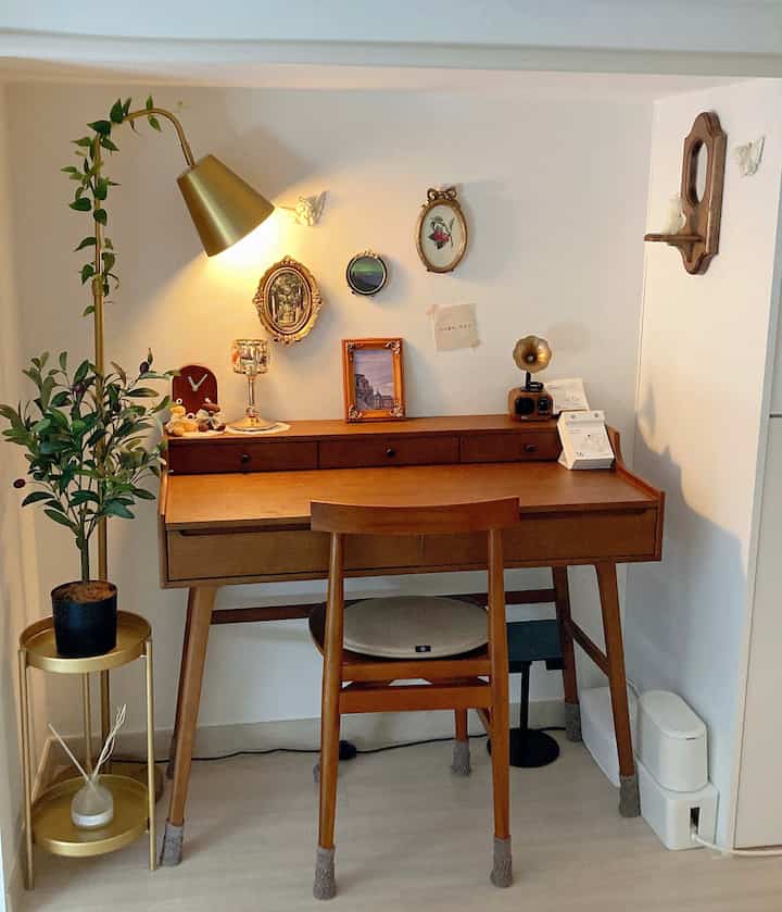Cozy home office space with antique desk and chair in gold and brown tones