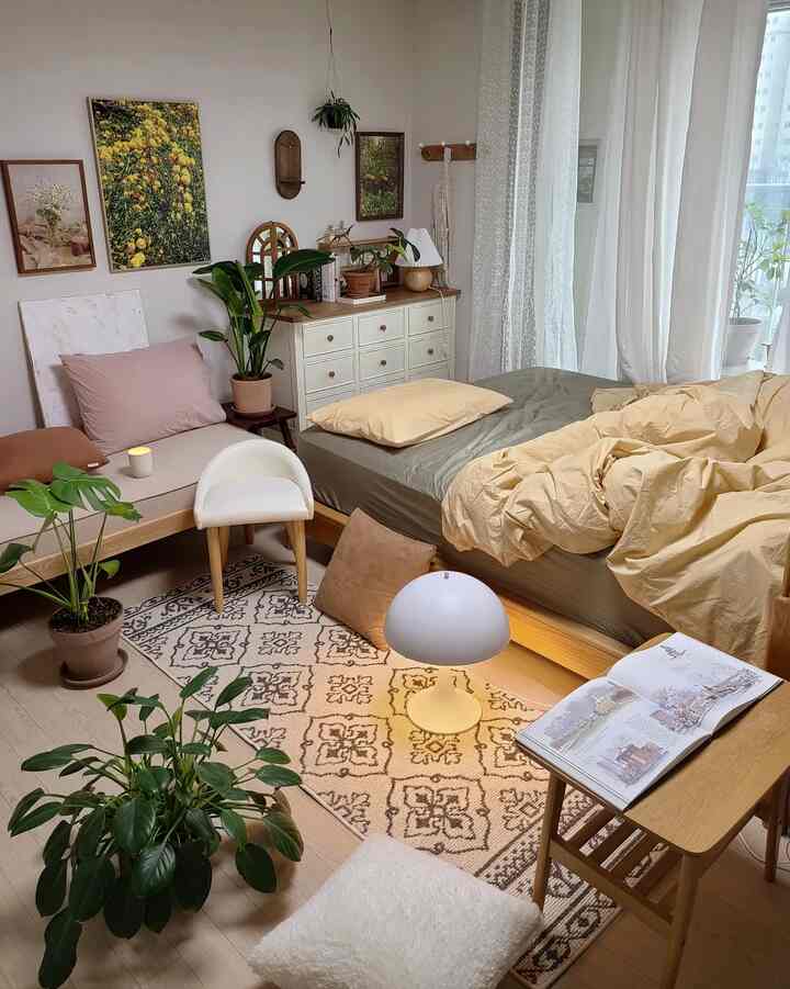 Natural-toned 6-tatami sized bedroom featuring wood furniture, plants, soft beige bedding and curtains creating a cozy atmosphere