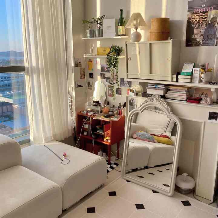 Bright living room with warm sunlight featuring white dominant colors and vintage style, modular sofa and decorative cabinet create cozy ambiance