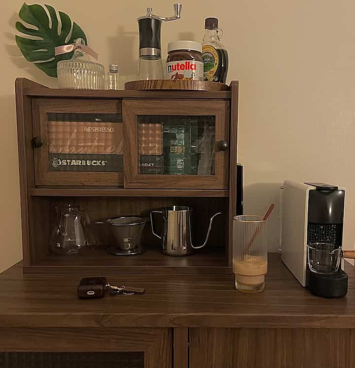 Warm brown wood tone home cafe area featuring capsule coffee machine and drip coffee set with cozy atmosphere