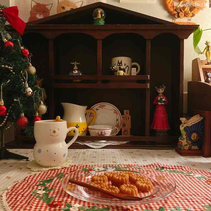 Red and wood tone home cafe space featuring Christmas decorations and mugs on a cozy table setting