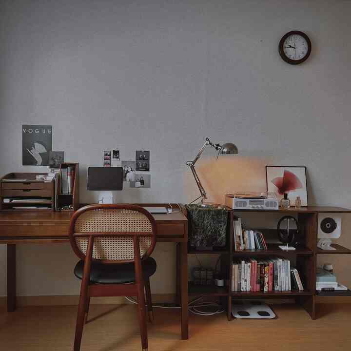 Dark brown wood-tone furniture and vintage decor create a cozy single household study and home cafe space