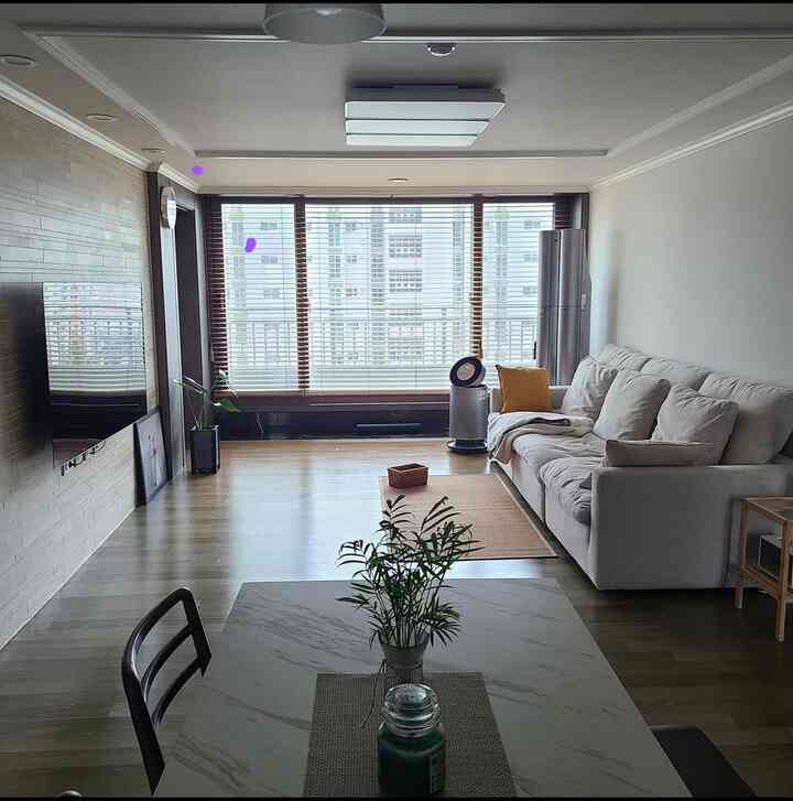 White and natural toned expanded veranda living room featuring a comfortable sofa, dining table, and natural rug with a cozy atmosphere