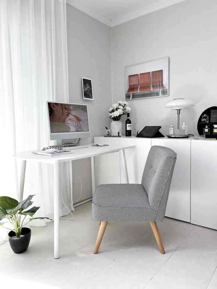 白とグレー調のホームオフィス、広いデスクとiMac、チェック柄の椅子が配置されたシンプルで清潔感のあるインテリア
