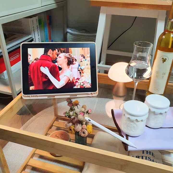 Natural tone small home cinema space featuring a coffee table with iPad and lamp arranged for cozy hobby use