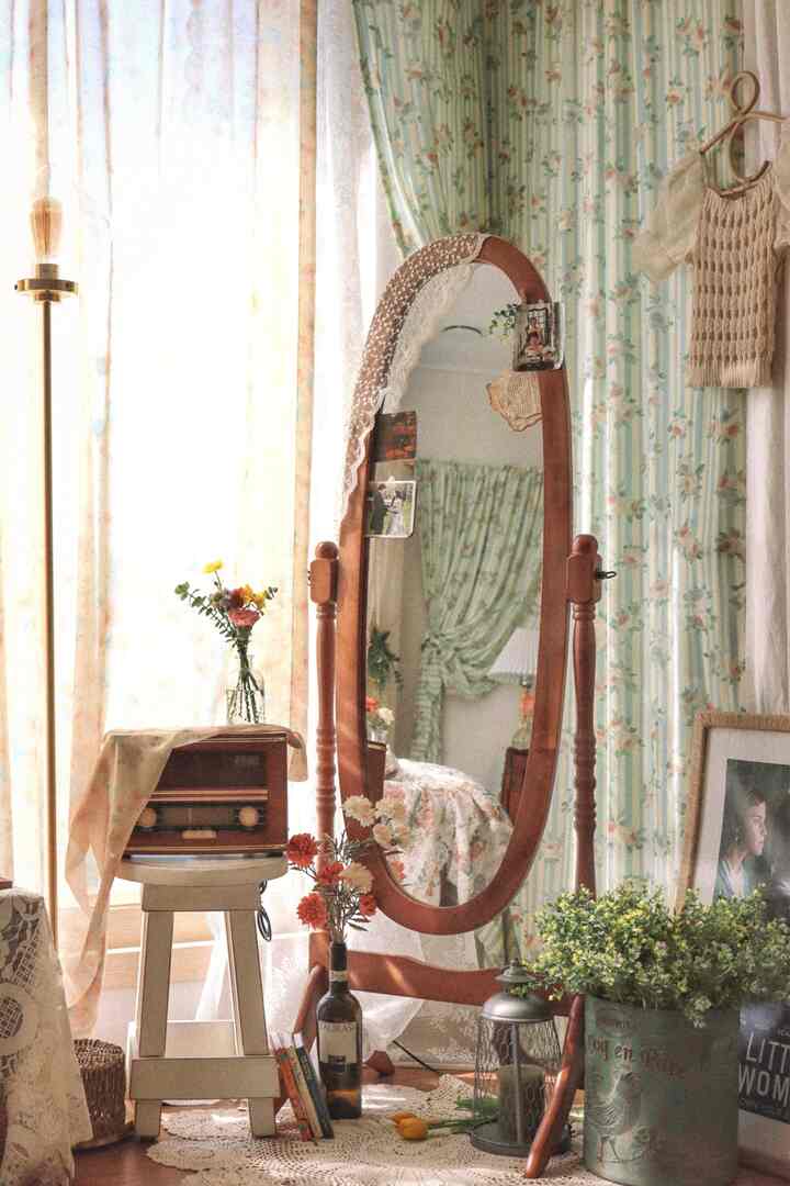 Wood tone living room corner with vintage furniture and floral curtains creating cozy atmosphere