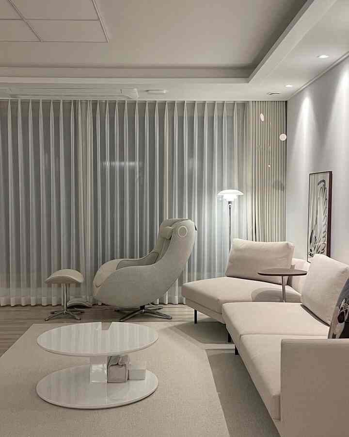 Light ivory toned living room featuring comfortable sofa and recliner with a modern, natural ambiance