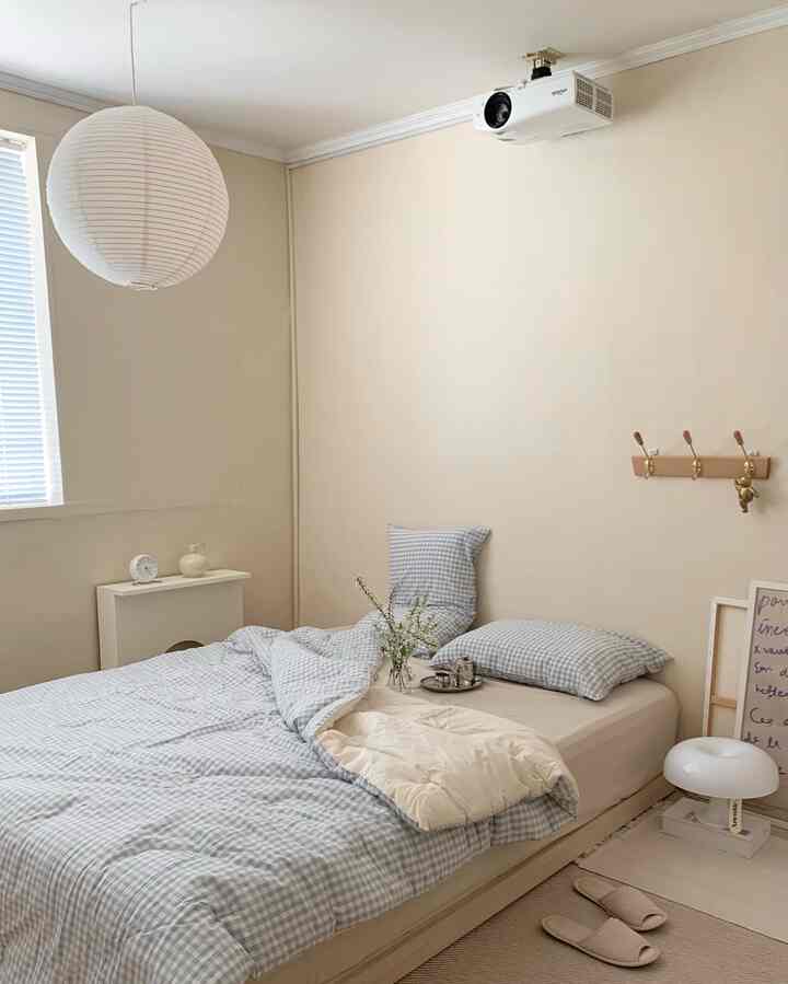 White and beige tone bedroom featuring blue checkered bedding, cozy and simple atmosphere