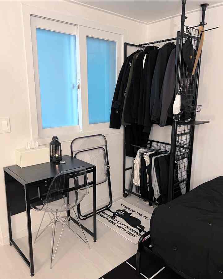 White walls and floor with black furniture create a simple modern single household home office space