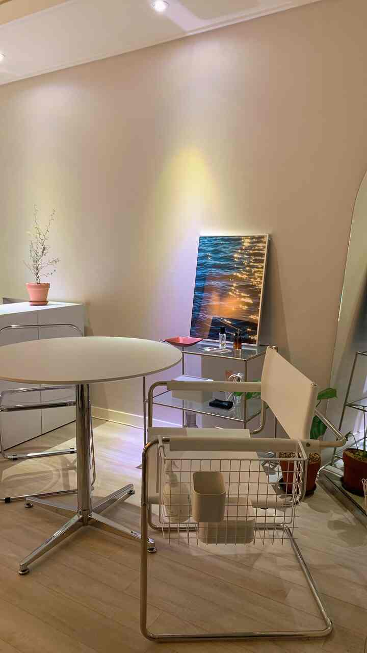 Modern minimal home cafe with warm beige walls and white furniture