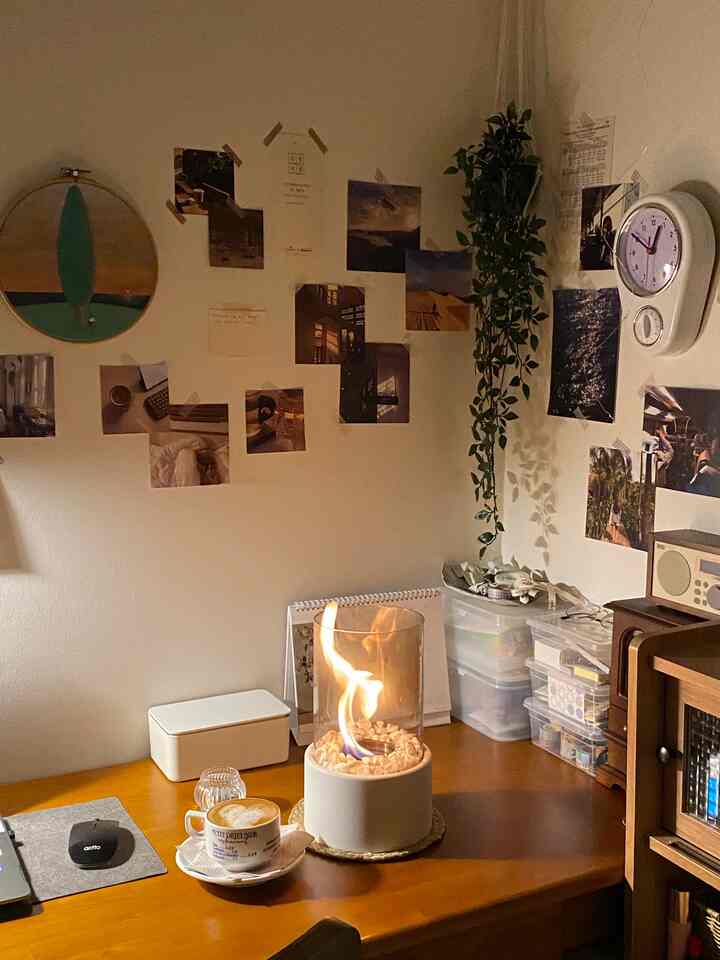 Warm natural-toned home office space featuring a wooden desk with an ethanol lamp and coffee mug, creating a cozy atmosphere