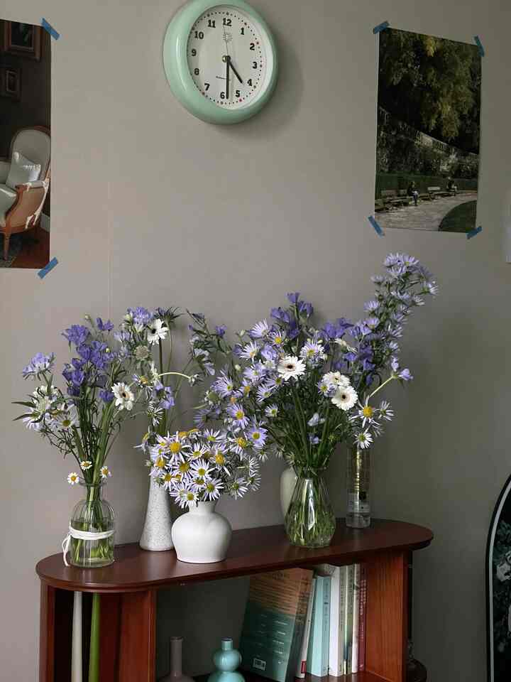 Vintage style living room with wood tone console table featuring lavender flowers and various home decor elements
