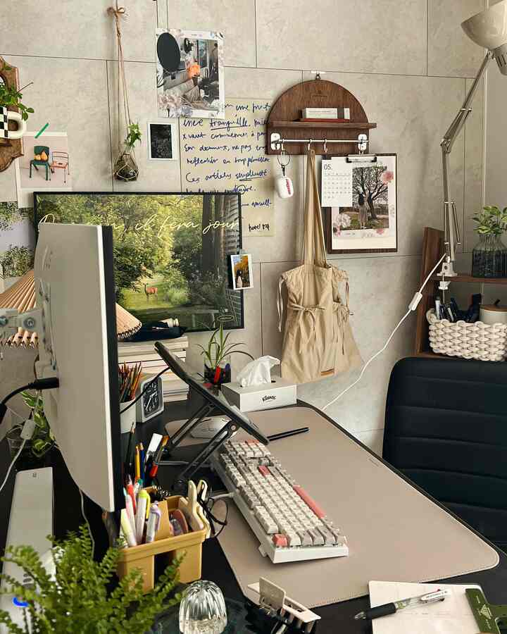 Natural-toned home office featuring desk, monitor, office chair, and wall decor creating a cozy workspace