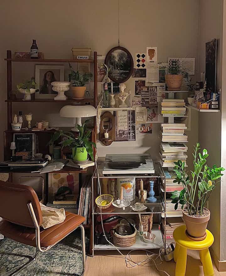 Natural-toned Nordic style home office space featuring a desk, plants, and book stacks with cozy ambiance