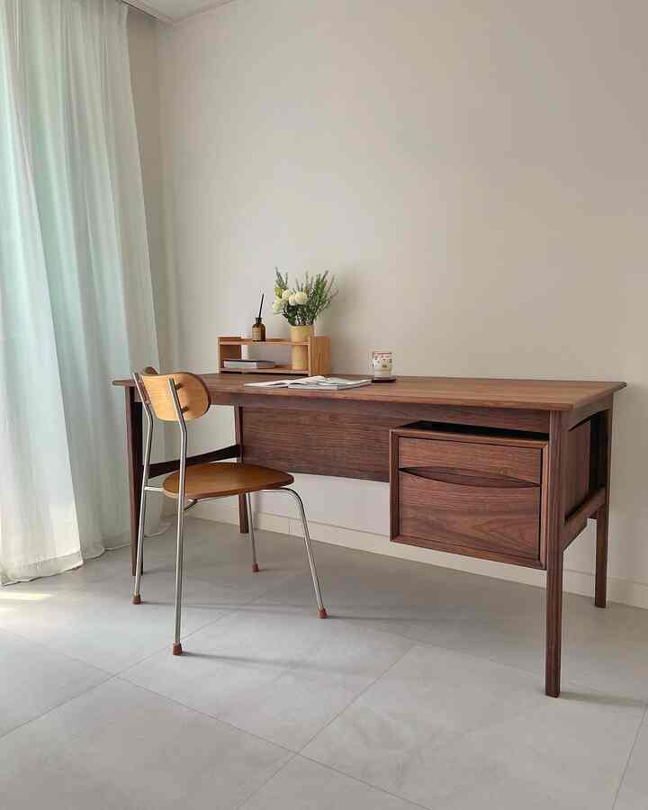 Cozy study space featuring a natural wooden desk against bright white walls