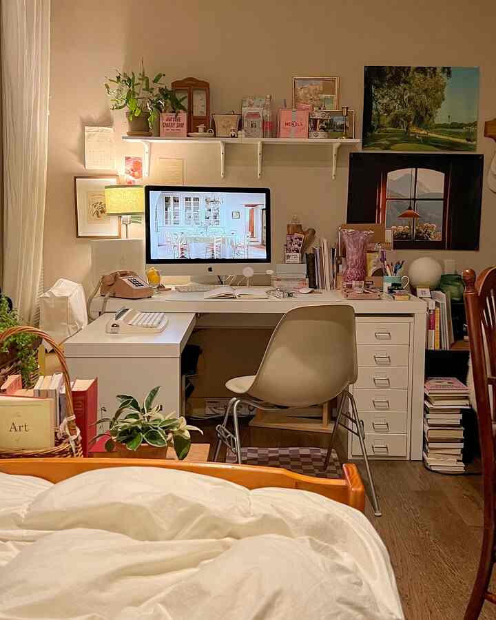 White-toned home office space featuring desk and dresser in a cozy workspace