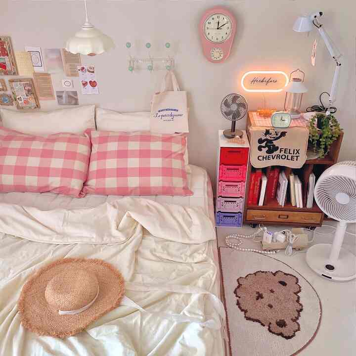 Natural-toned bedroom featuring pink check bedding and a vintage clock with cozy decor