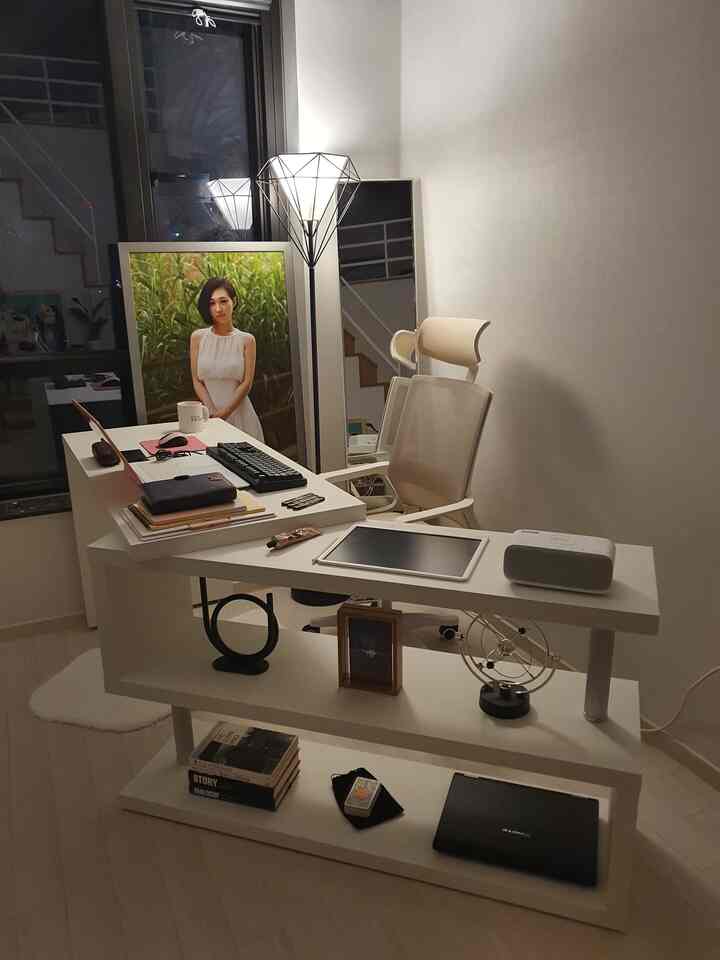 Modern white-toned officetel study featuring a white desk with office chair, full-length mirror, and geometric floor lamp furnishing a clean workspace
