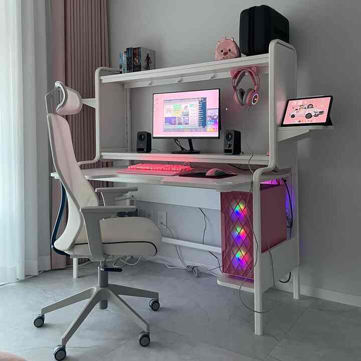 White and pink toned compact home office featuring a gaming desk and chair in a sleek workspace