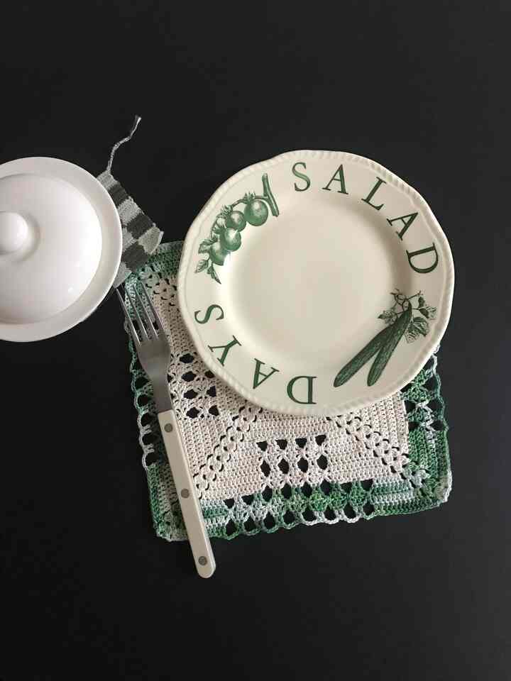 Navy-toned kitchenware featuring vintage plate and handmade crocheted kitchen towel on stylish tableware setting