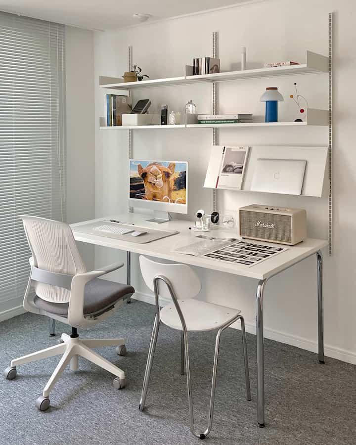 White and gray toned home office featuring a clean desk and chairs in a modern workspace