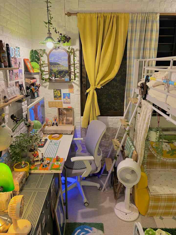 A cozy studio apartment home office in bright yellow and white tones featuring a loft bed, desk, and pendant lighting
