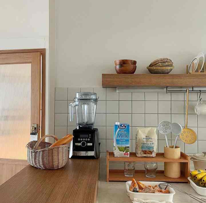 ナチュラルトーンの木製カウンターとブレンダー、調理器具が配置された清潔感のあるキッチン