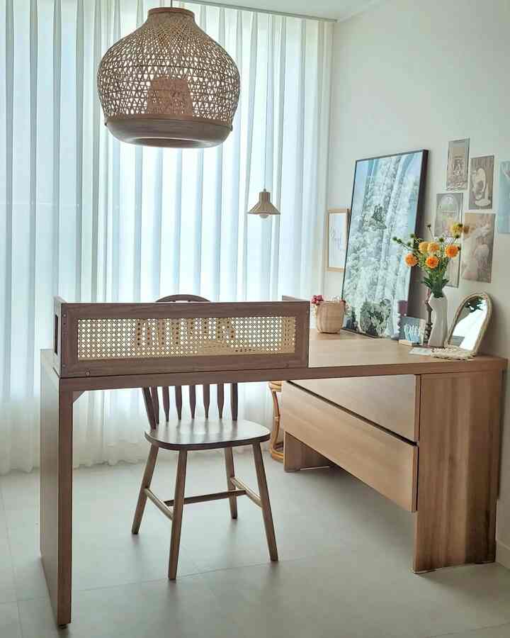 Natural wood-tone home office space featuring a rattan pendant light and minimalist desk with a clean, warm atmosphere