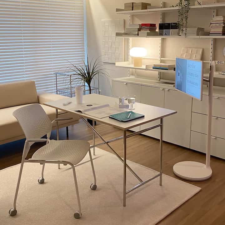 Bright white-tone home office space featuring transparent white chair and simple desk with natural modern style interior