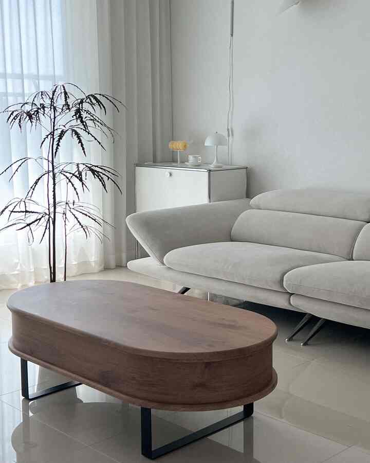 Wood tone and white harmony in a living room featuring a lift-up table and a light sofa with a clean natural modern atmosphere