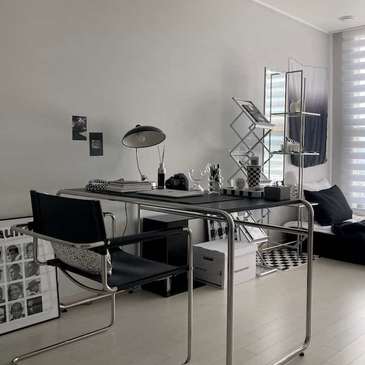 Mid-Century Modern home office with white walls and black furniture creating a stylish workspace