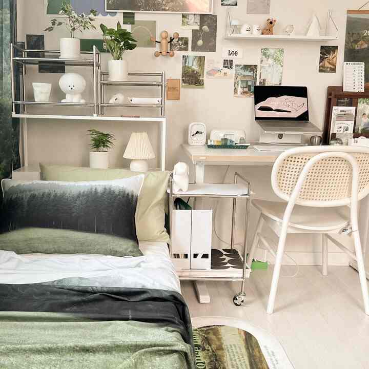 Natural-tone studio bedroom featuring a desk, storage shelves, and cozy home office setup