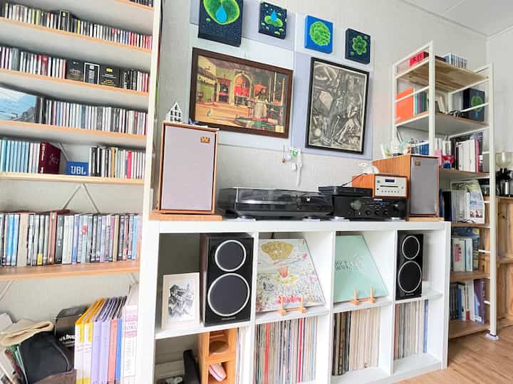 Natural tone study-living room featuring IKEA bookshelves and Denon turntable audio equipment in a tidy setup