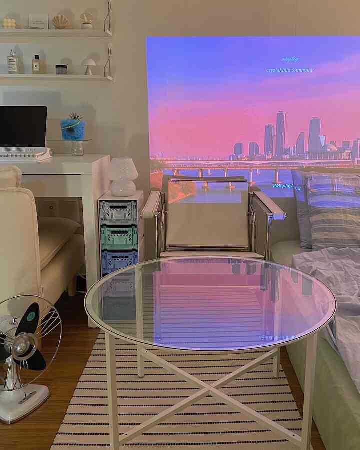 White and brown toned studio apartment featuring modern furniture and storage boxes in a cozy space