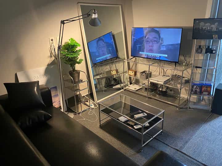 Modern living room in black and silver tones, featuring sleek metal shelves and furniture arranged neatly for comfort