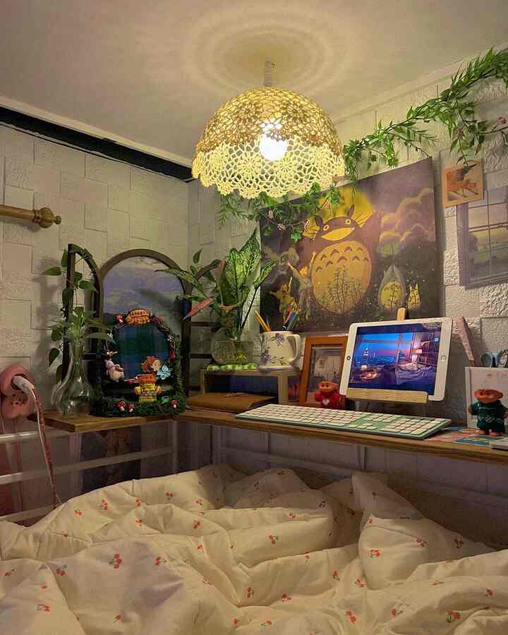 Warm yellow lighting and natural wood-tone desk with plants in a small, compact single household home office space