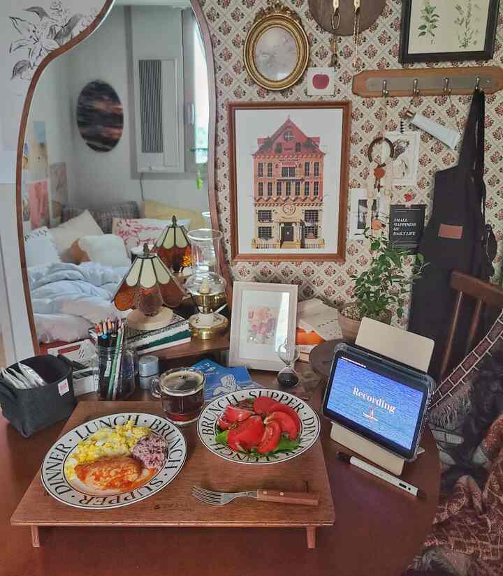 Wood tone vintage dining room featuring a round table with brunch plates and home cafe elements, creating a cozy atmosphere