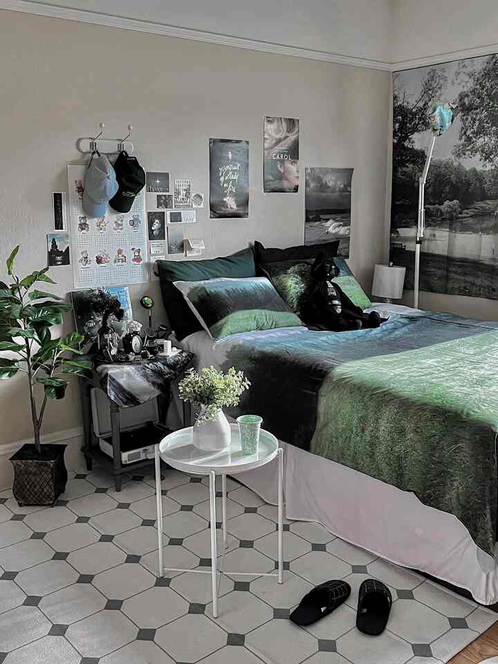 Natural-toned bedroom featuring blue-green bedding, a side table, and plants creating a cozy atmosphere